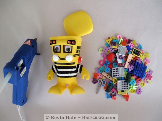 Step 7: Hot glue some school supplies to the Color Blanks figure Step 7: Hot glue some school supplies to the Color Blanks figure